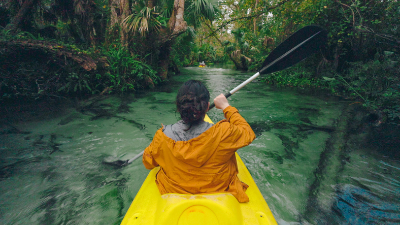 Lady Kayaking through a Jungle Spring River - High Angle - Florida Freshwater River Springs
